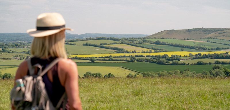 Alexia looking out across fields towards the hills