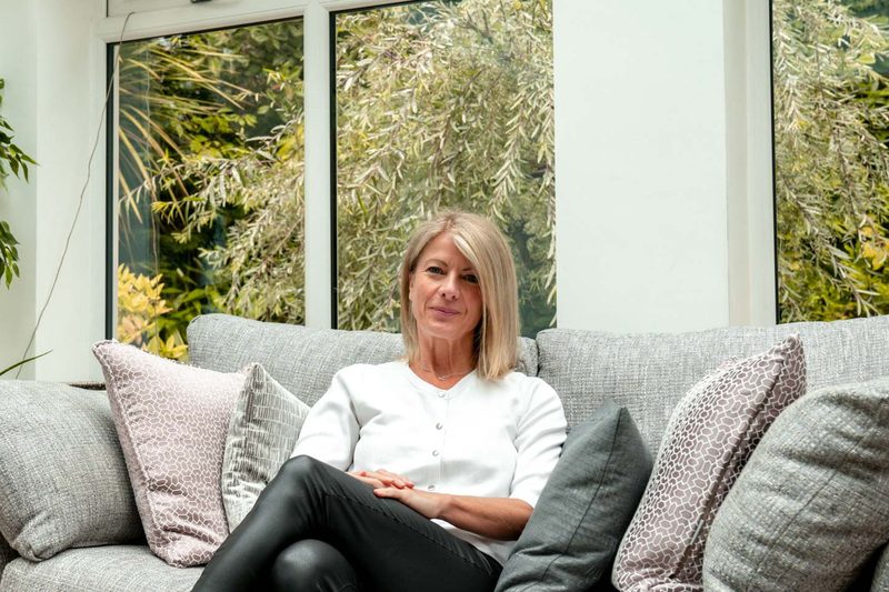Alexia Bylett sitting calmly on a sofa
